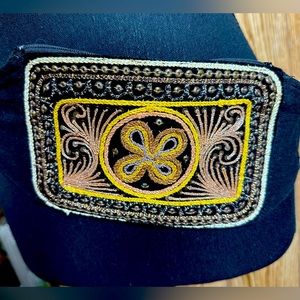 Embroidered women's belt bag with adjustable waist.